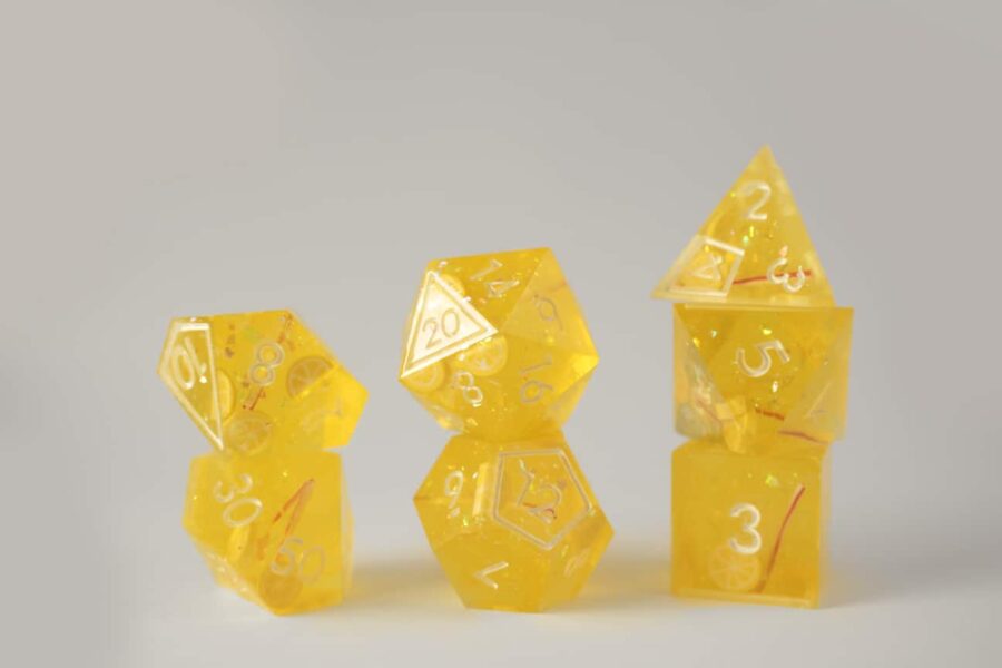 Sparkly yellow dice with lemon fruit slices, and red and white straws to look like a refreshing glass of lemonade